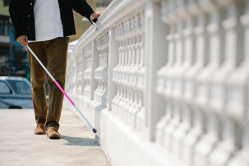 A person walking with a white cane