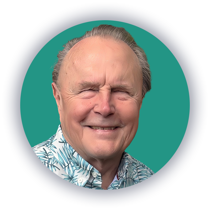 Ted Henter, the Vista Honors honoree, in front of a teal background, smiling and wearing a blue, white, and green Hawaiian shirt.